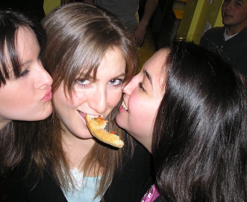 Pizza crust gets two young ladies to kiss a third young lady