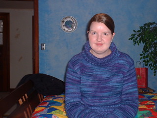 Purple sweater in bedroom